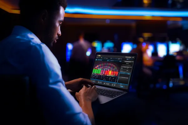 A close-up shot of golden coins falling around a spinning roulette wheel, representing immersive casino action at JILI697.