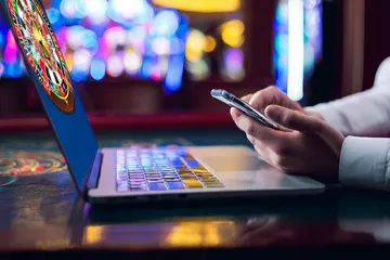 A woman smiling by bright slot machines showing lucky symbols, showcasing the exciting slot offerings at JILI697.